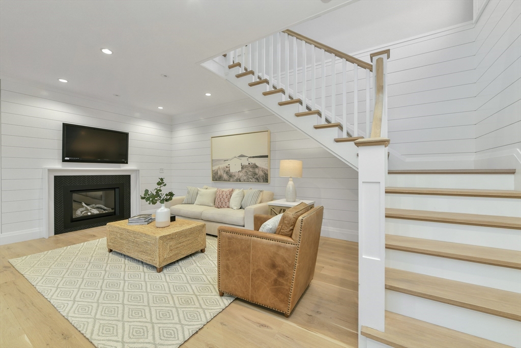 66 Jerusalem Road Cohasset, MA 02025 - Photo 20 of 40 a living room with furniture a fireplace and a flat screen tv