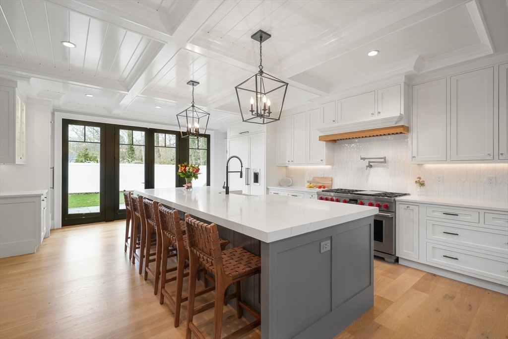 66 Jerusalem Road Cohasset, MA 02025 - Photo 2 of 40 a kitchen with stainless steel appliances a table chairs in it and white cabinets