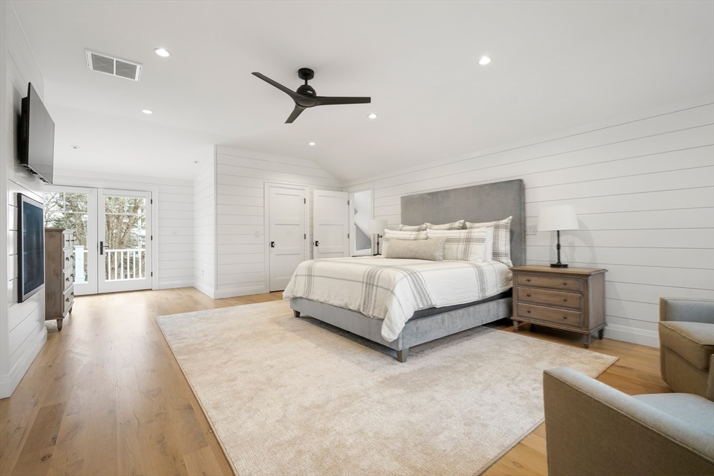 66 Jerusalem Road Cohasset, MA 02025 - Photo 23 of 40 a spacious bedroom with a bed and a flat screen tv