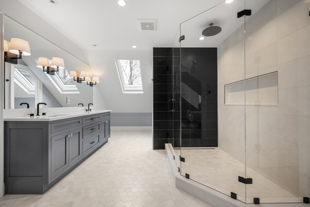 66 Jerusalem Road Cohasset, MA 02025 - Photo 25 of 40 a bathroom with a double vanity sink a mirror and a bathtub