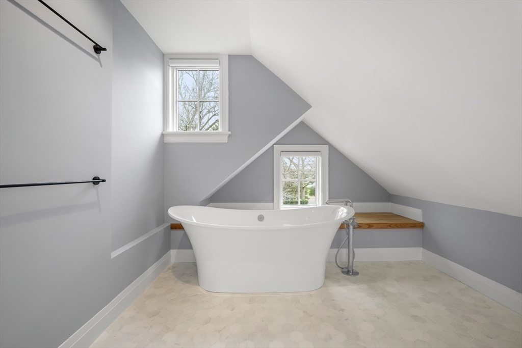 66 Jerusalem Road Cohasset, MA 02025 - Photo 27 of 40 a white bath tub sitting in a bathroom next to a window