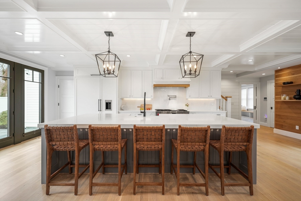 66 Jerusalem Road Cohasset, MA 02025 - Photo 3 of 40 a dining room with wooden floor a chandelier a wooden table and chairs
