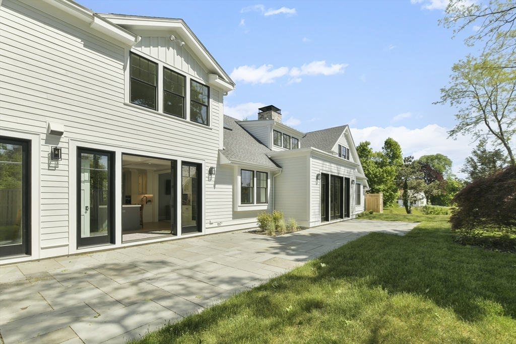 66 Jerusalem Road Cohasset, MA 02025 - Photo 38 of 40 a front view of a house with a yard and potted plants