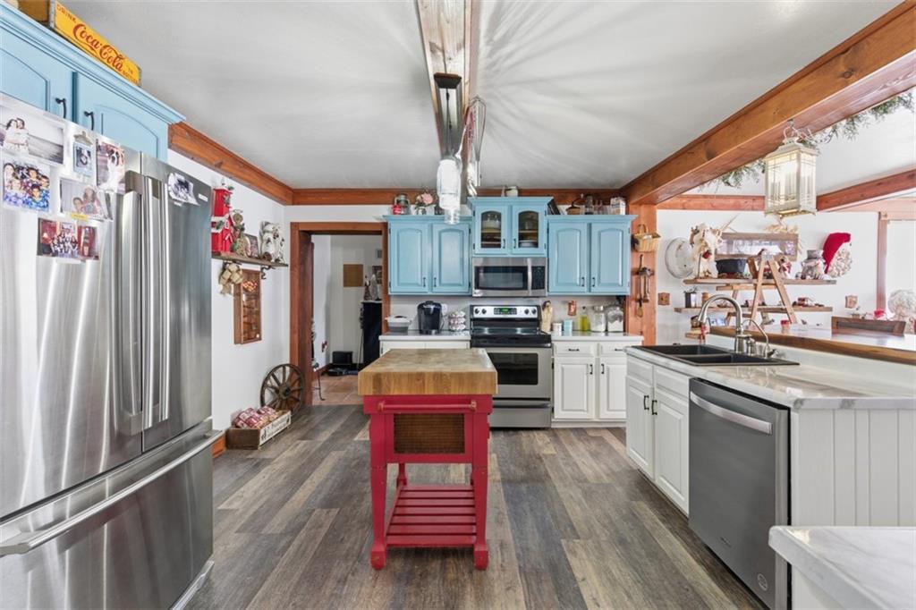 2976 Henderson Road Washington, PA 15301 - Photo 13 of 50 a kitchen with stainless steel appliances granite countertop a refrigerator a sink dishwasher a stove and white countertops with wooden floor
