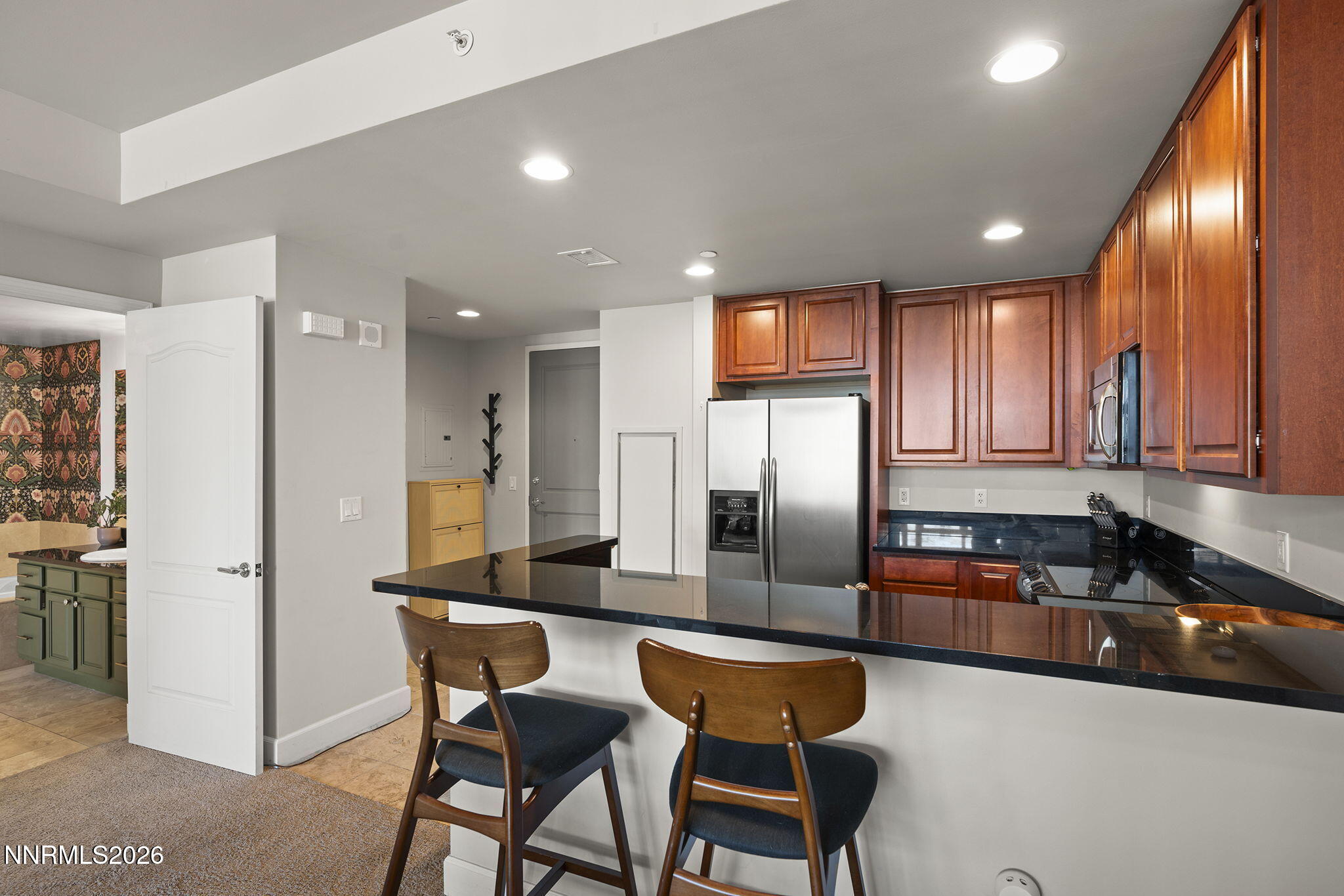 50 North Sierra Street, Unit 805 Reno, NV 89501 - Photo 10 of 23 a kitchen with stainless steel appliances granite countertop a refrigerator a sink a stove a dining table and chairs
