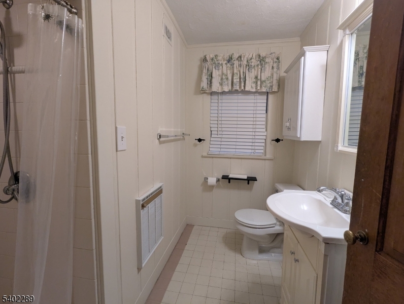 82 Winsor Place Glen Ridge, NJ 07028 - Photo 14 of 17 a bathroom with a toilet sink and mirror