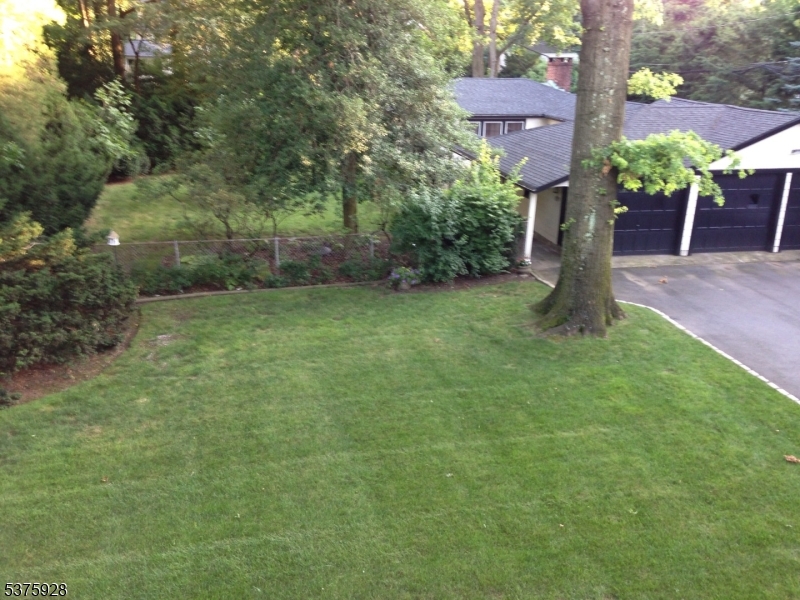 82 Winsor Place Glen Ridge, NJ 07028 - Photo 17 of 17 a house is sitting in middle od the grass