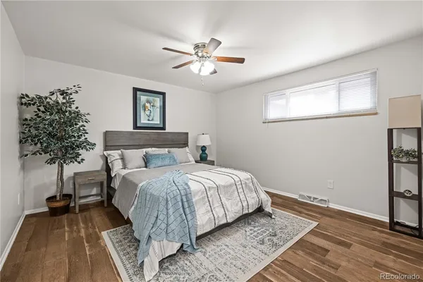 a bedroom with a bed and a potted plant