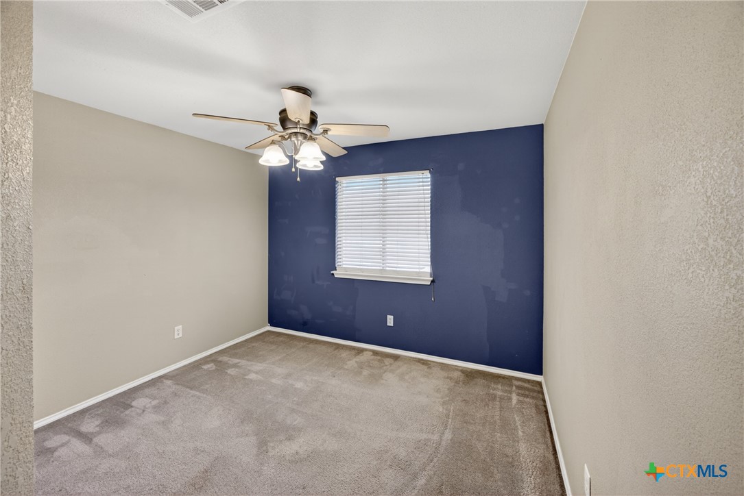 7015 Rickey Drive Temple, TX 76502 - Photo 22 of 29 an empty room with windows and fan