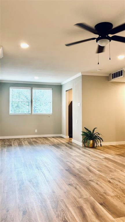4603 Junius Street, Unit 8 Dallas, TX 75246 - Photo 3 of 16 View of living room and dining room with wood finished floors, recessed lighting, and ornamental molding.