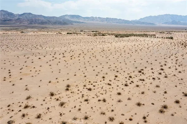 a view of an ocean beach and mountain