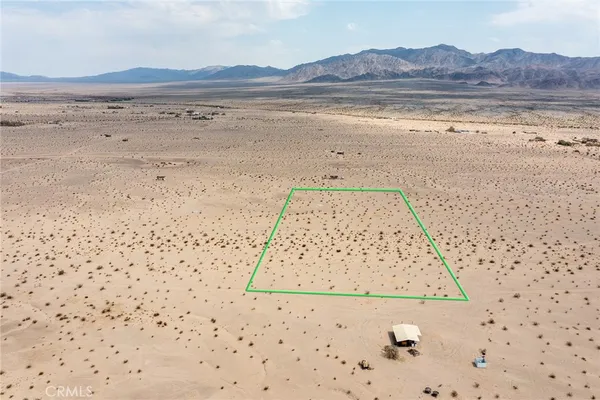 a view of an ocean beach and a mountain