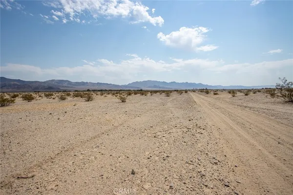 a view of an ocean beach and mountain