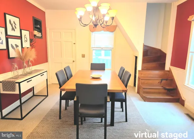 a view of a dining room with furniture and a chandelier
