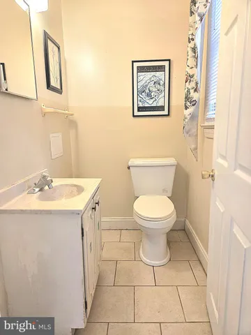 a bathroom with a toilet a sink and a mirror