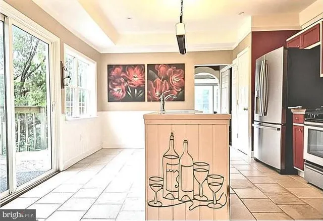 a kitchen with stainless steel appliances a refrigerator and a stove top oven