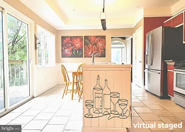 a kitchen with stainless steel appliances granite countertop a refrigerator and a stove top oven