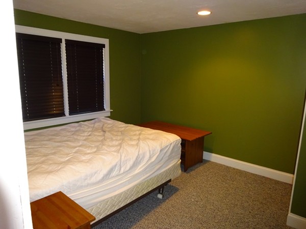 24 Gitchee Gummie Road Wareham, MA 02532 - Photo 13 of 30 a bed sitting in a bedroom next to a small yard