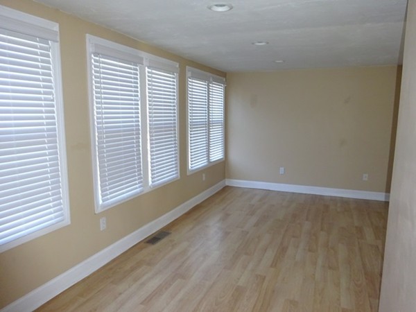 24 Gitchee Gummie Road Wareham, MA 02532 - Photo 3 of 30 a view of an empty room with wooden floor and a window