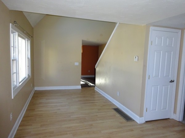 24 Gitchee Gummie Road Wareham, MA 02532 - Photo 4 of 30 a view of an empty room with wooden floor and a window