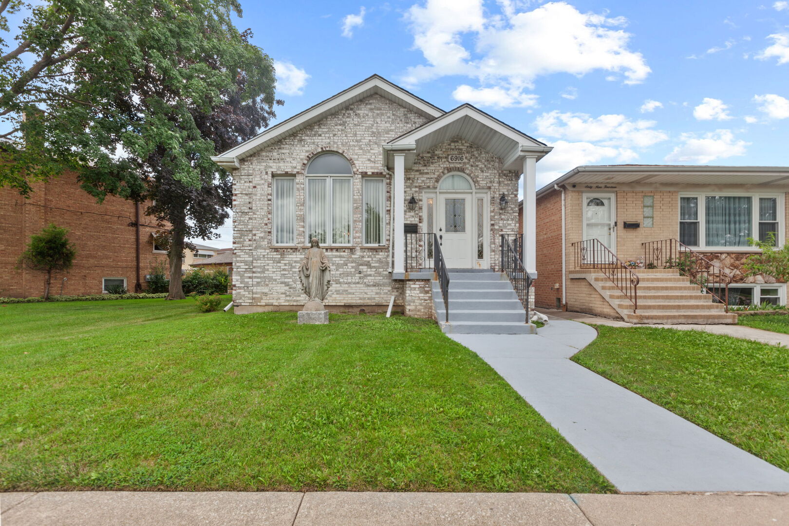 a front view of house with yard and outdoor seating