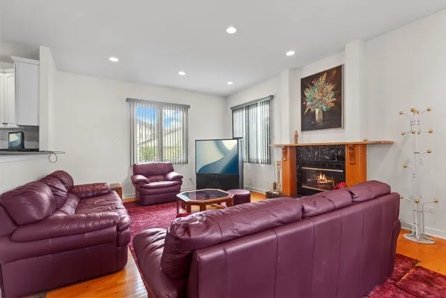 a living room with furniture a fireplace and a flat screen tv