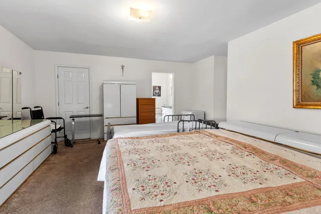 a living room with furniture and a dresser
