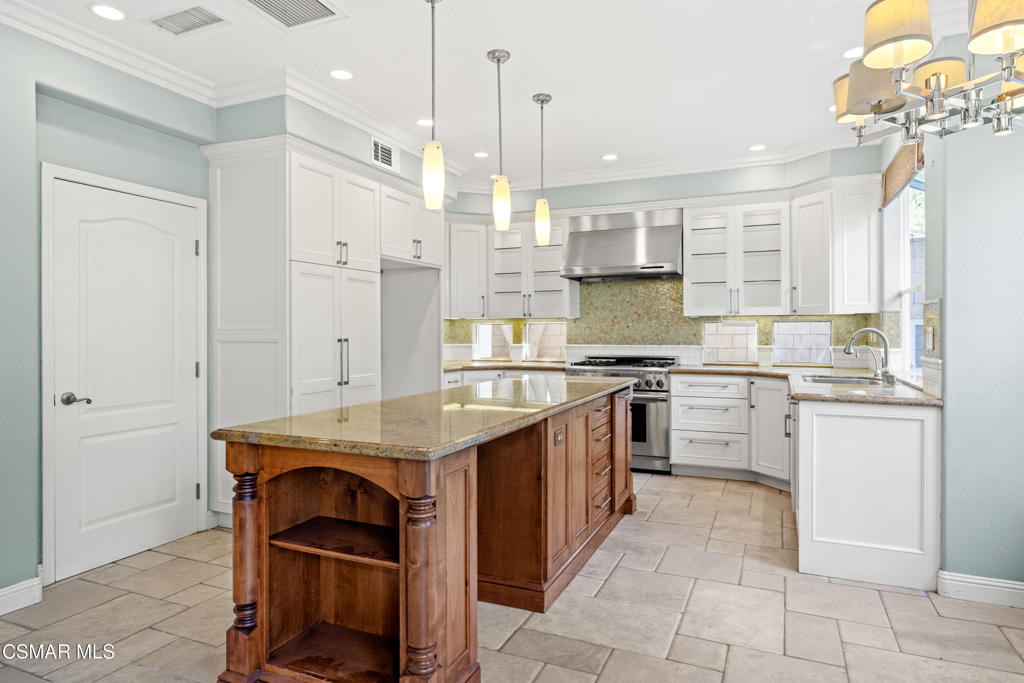 3881 Timberridge Road Moorpark, CA 93021 - Photo 11 of 28 a kitchen with stainless steel appliances granite countertop a stove top oven a sink dishwasher and a refrigerator