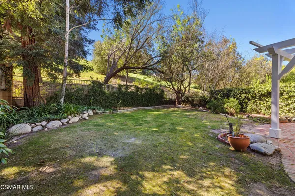 a view of a backyard with table and chairs and plants