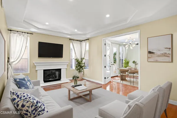 a living room with furniture a flat screen tv and a fireplace