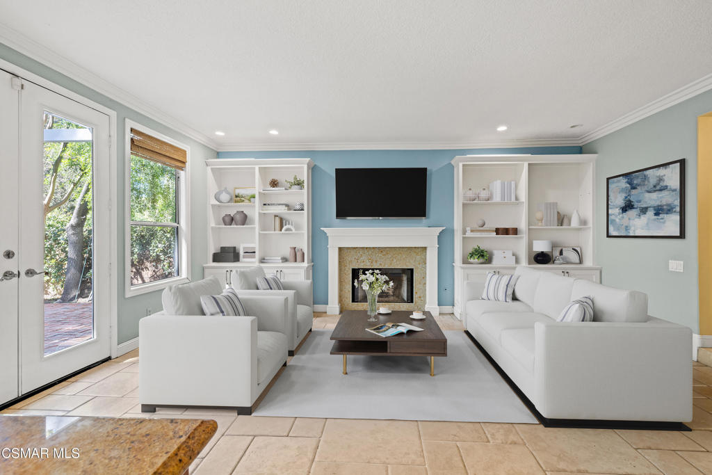 3881 Timberridge Road Moorpark, CA 93021 - Photo 8 of 28 a living room with furniture a fireplace and a flat screen tv