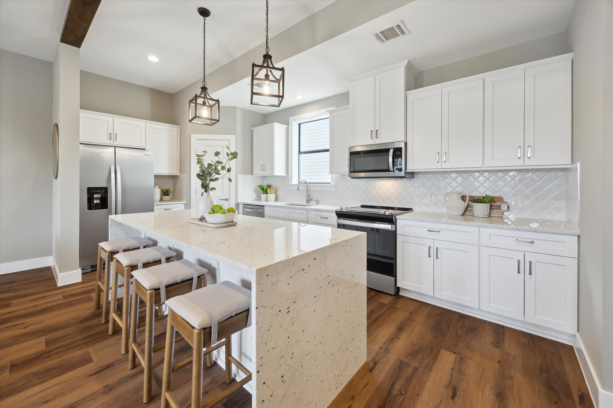 3102 Eunice Street Houston, TX 77009 - Photo 13 of 29 a kitchen with stainless steel appliances granite countertop a stove a refrigerator a sink dishwasher a stove and white cabinets with wooden floor