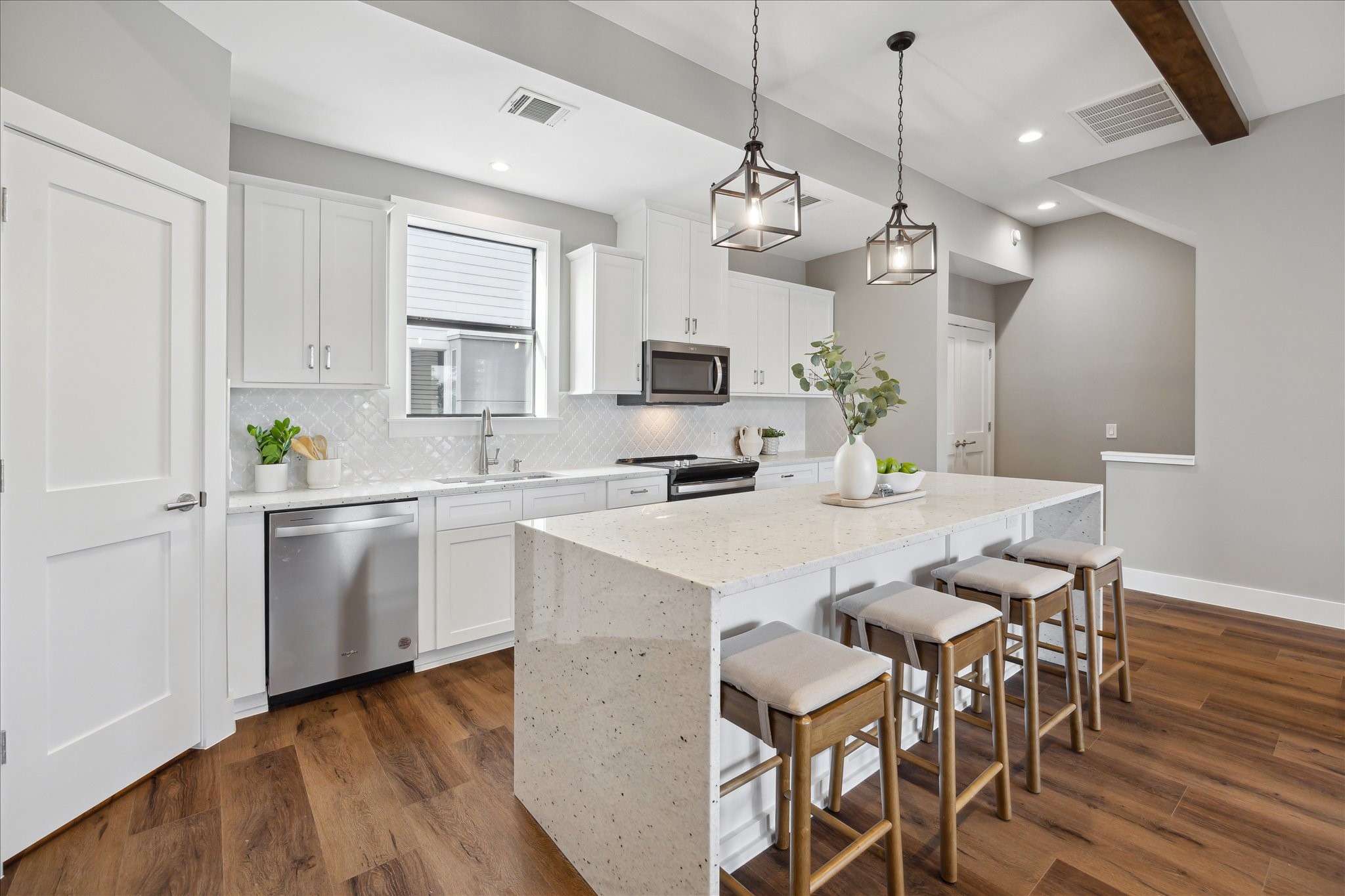 3102 Eunice Street Houston, TX 77009 - Photo 14 of 29 a kitchen with kitchen island granite countertop a sink a counter space appliances and cabinets