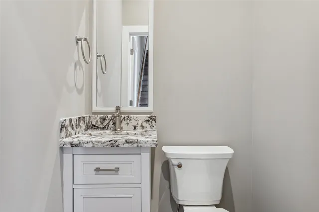 a kitchen with kitchen island granite countertop a sink a counter space appliances and cabinets