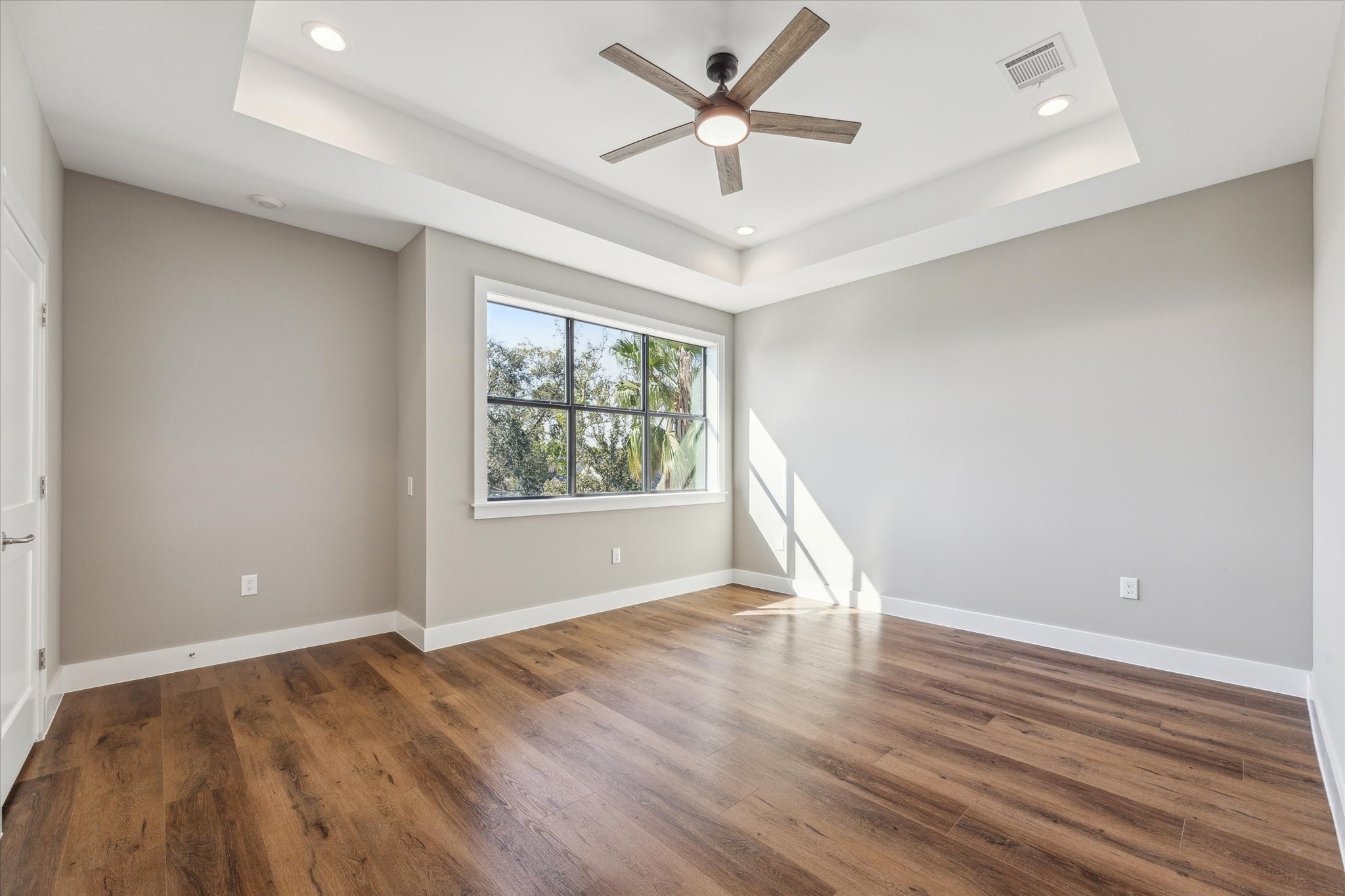 3102 Eunice Street Houston, TX 77009 - Photo 16 of 29 an empty room with wooden floor and windows