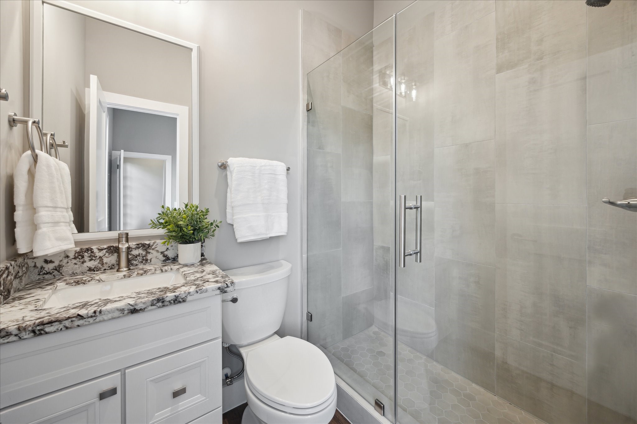 3102 Eunice Street Houston, TX 77009 - Photo 24 of 29 a bathroom with a granite countertop sink toilet a mirror and shower