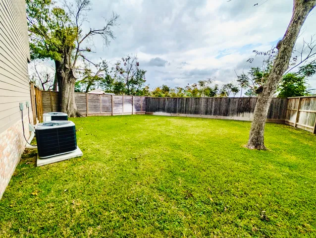 a bathroom with a granite countertop sink toilet a mirror and shower