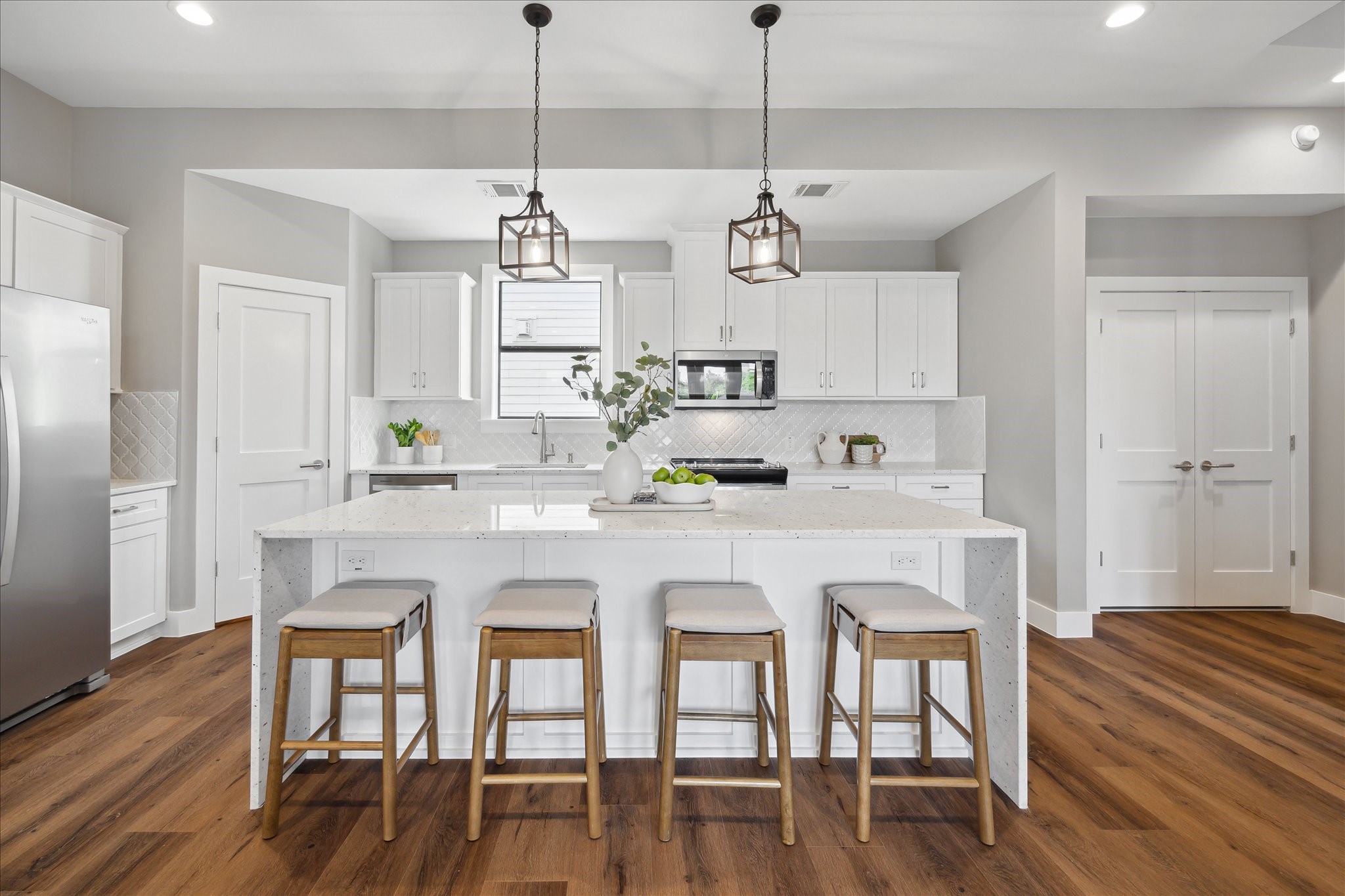3102 Eunice Street Houston, TX 77009 - Photo 3 of 29 a kitchen with stainless steel appliances granite countertop a dining table chairs and wooden floor