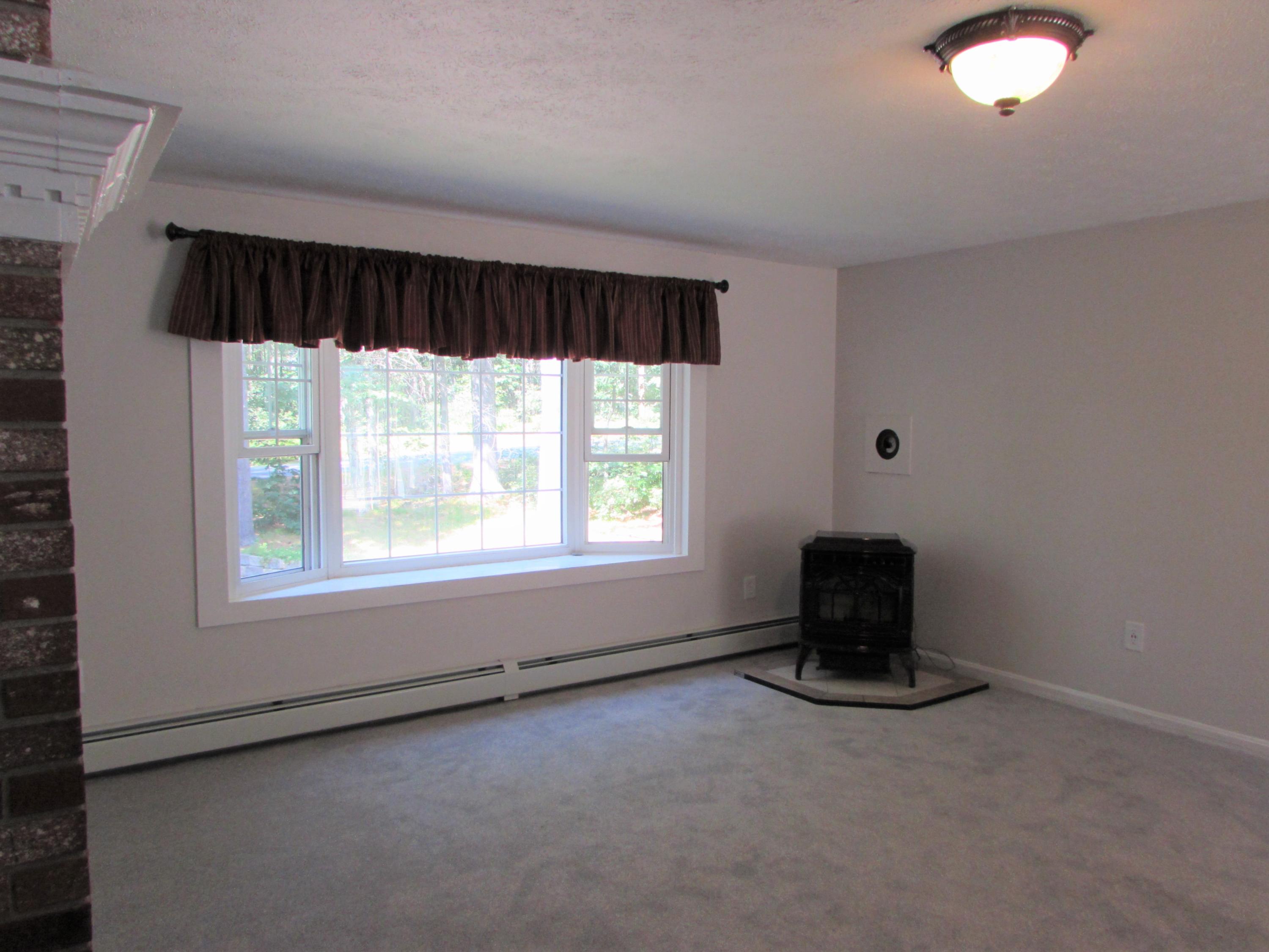 990 Quarry Road Wells, ME 04090 - Photo 19 of 37 Living room w/ pellet stove