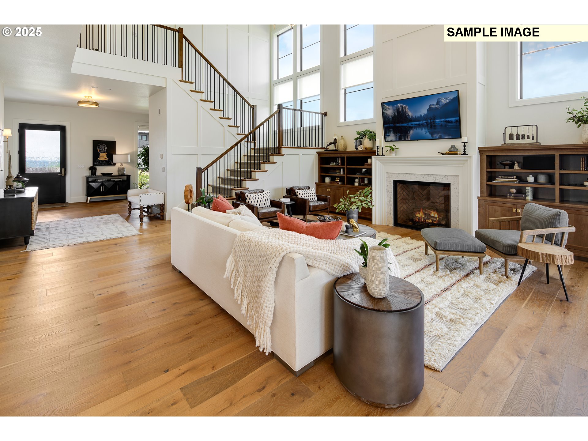 645 Northwest Halifax Street, Unit LOT 7 Camas, WA 98607 - Photo 6 of 13 a living room with furniture a fireplace and a flat screen tv