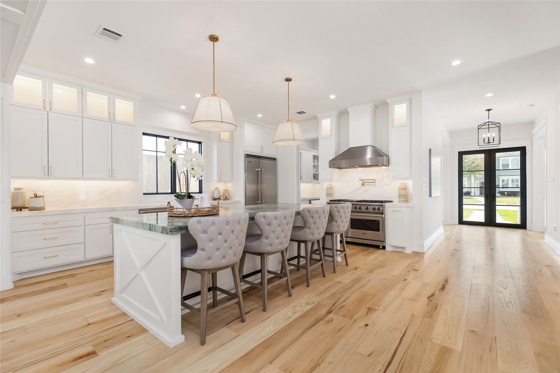934 West 43rd Street Houston, TX 77018 - Photo 7 of 15 a large kitchen with granite countertop a stove a sink a dining table and chairs with wooden floor