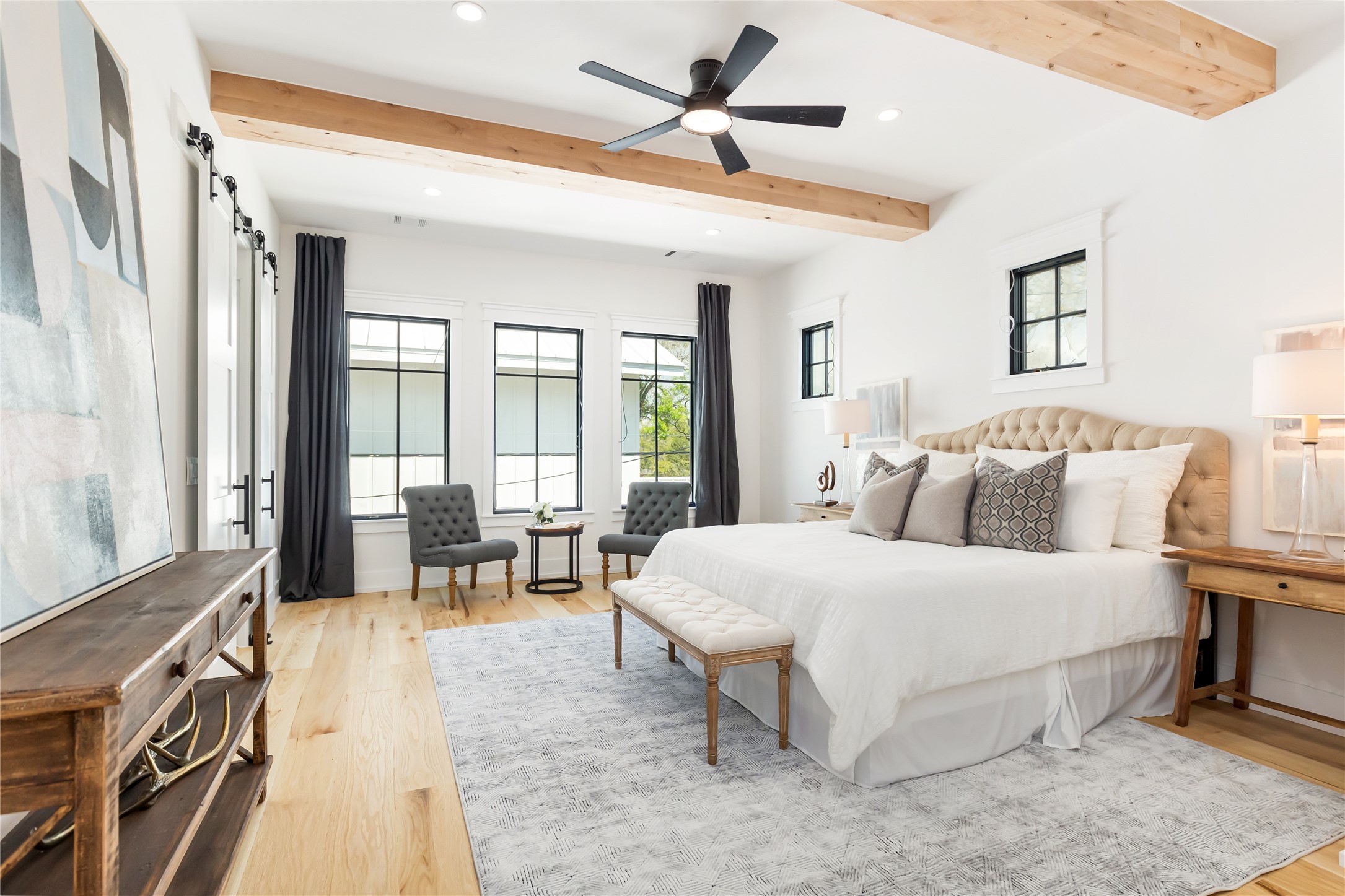 934 West 43rd Street Houston, TX 77018 - Photo 10 of 15 a spacious bedroom with a large bed and a chandelier fan