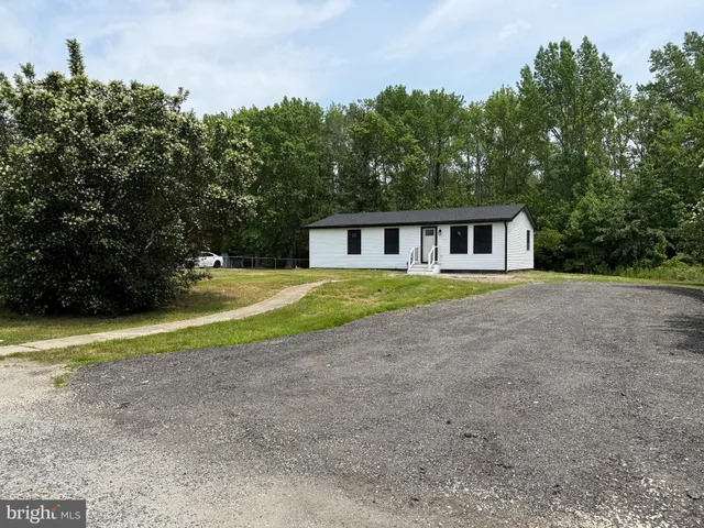 a view of a house with pool and a yard