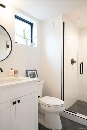 a bathroom with a toilet and a shower