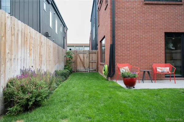 a backyard of a house with outdoor seating