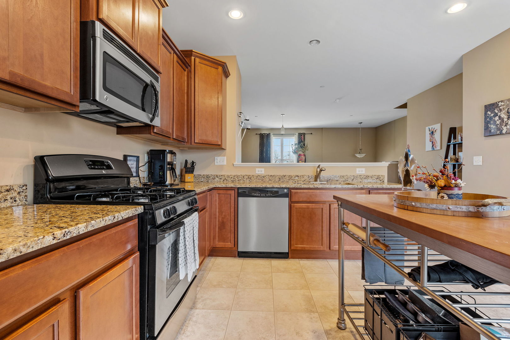 10338 Kerry Ridge Court Chicago Ridge, IL 60415 - Photo 8 of 16 a kitchen with stainless steel appliances granite countertop a stove top oven a sink dishwasher and cabinets with wooden floor