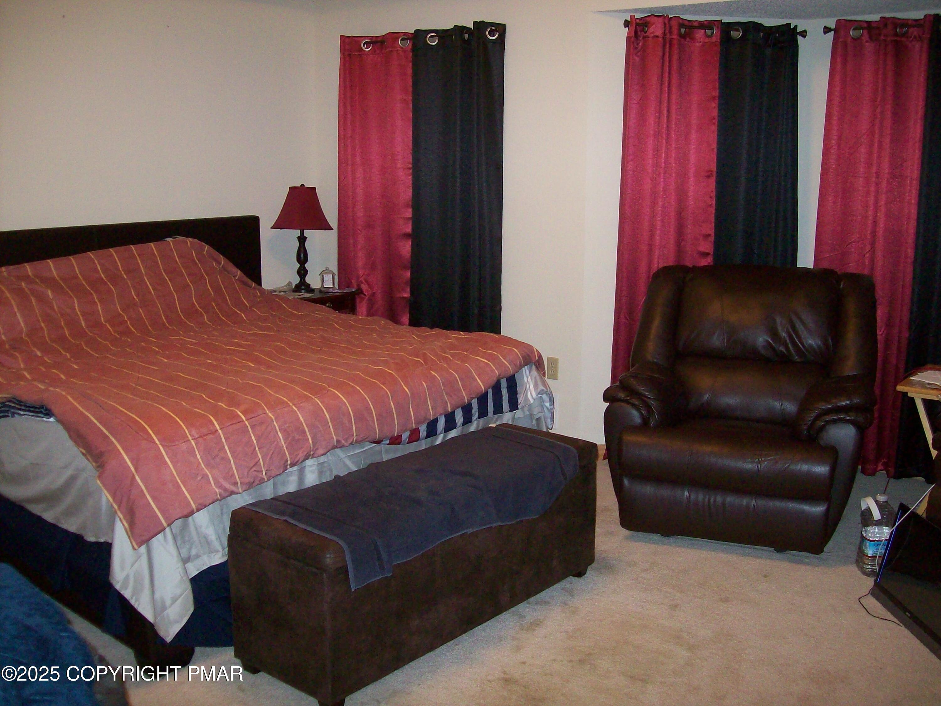 106 Bull Run Long Pond, PA 18334 - Photo 23 of 31 a bedroom with a bed and a chair