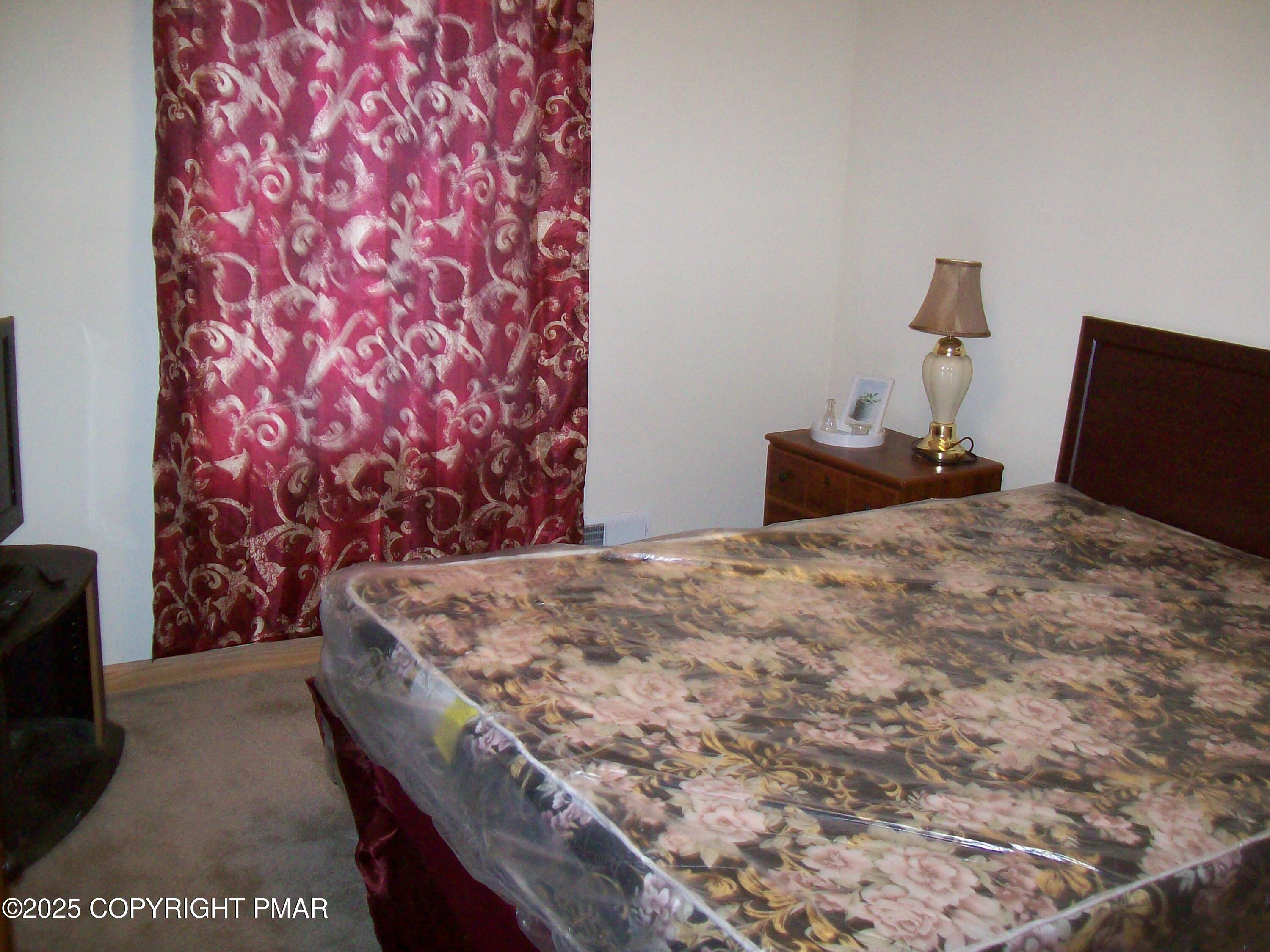 106 Bull Run Long Pond, PA 18334 - Photo 28 of 31 a bed sitting in a bedroom and dresser