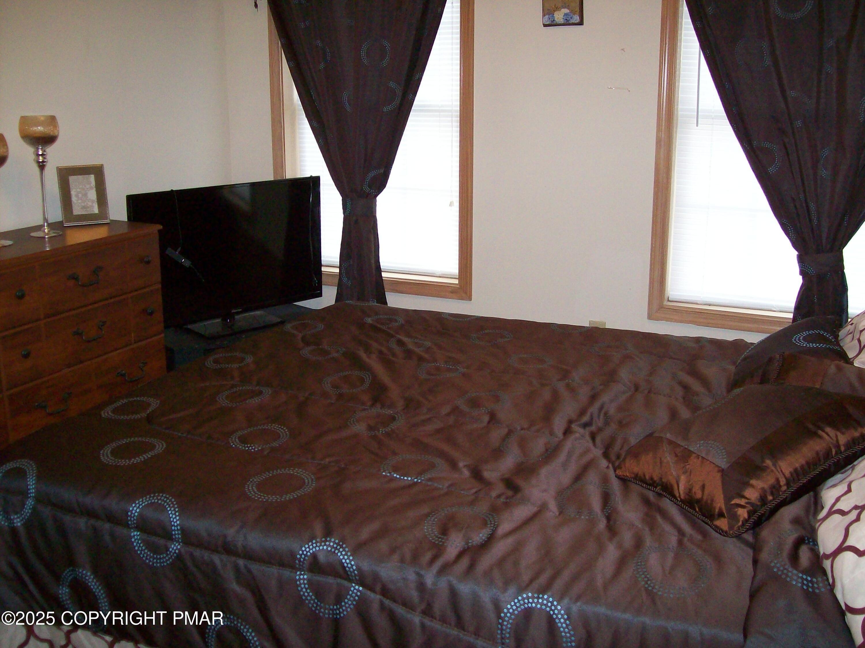 106 Bull Run Long Pond, PA 18334 - Photo 30 of 31 a living room with a couch and a flat screen tv