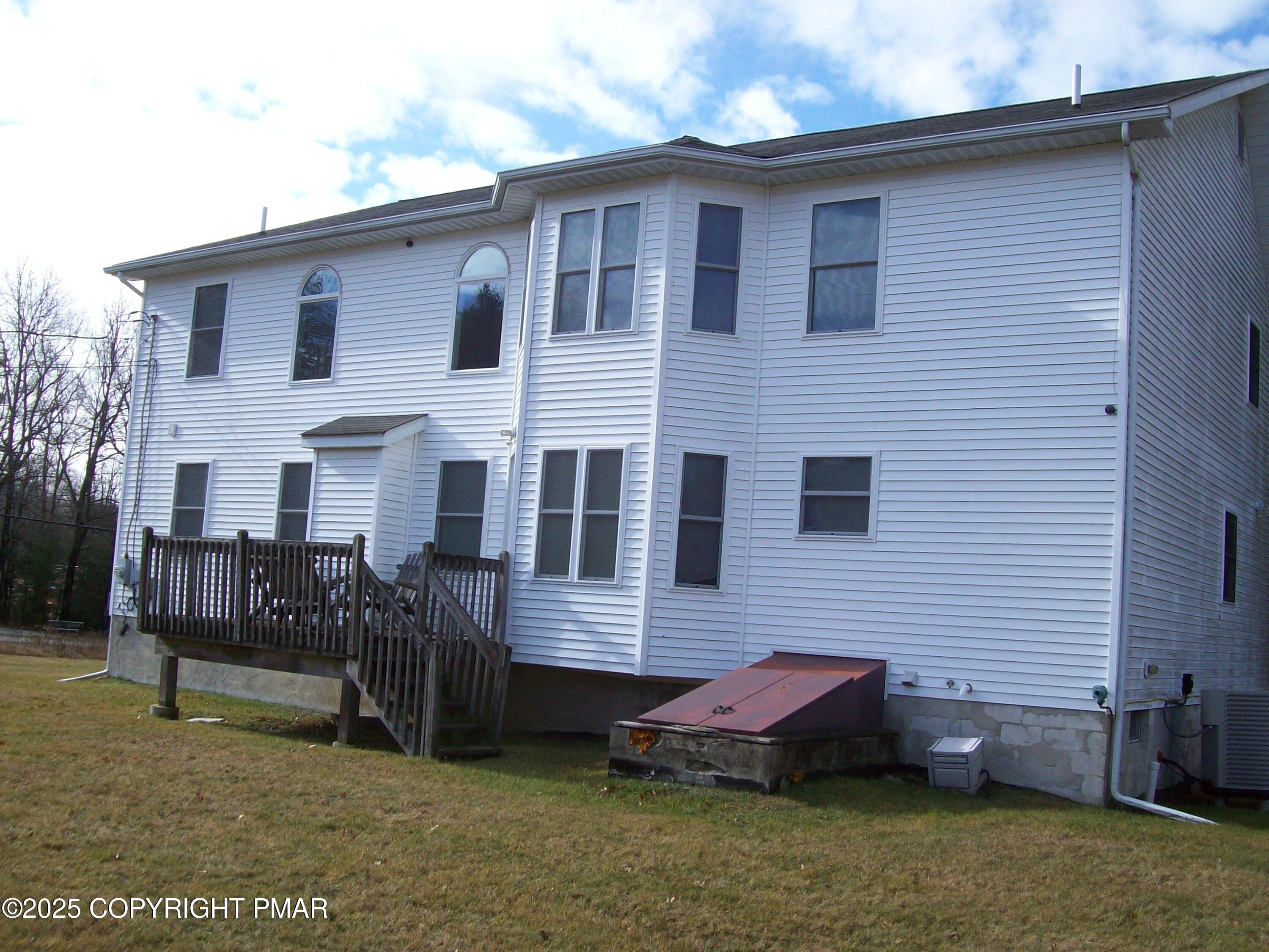 106 Bull Run Long Pond, PA 18334 - Photo 4 of 31 a view of a house with a backyard and chairs